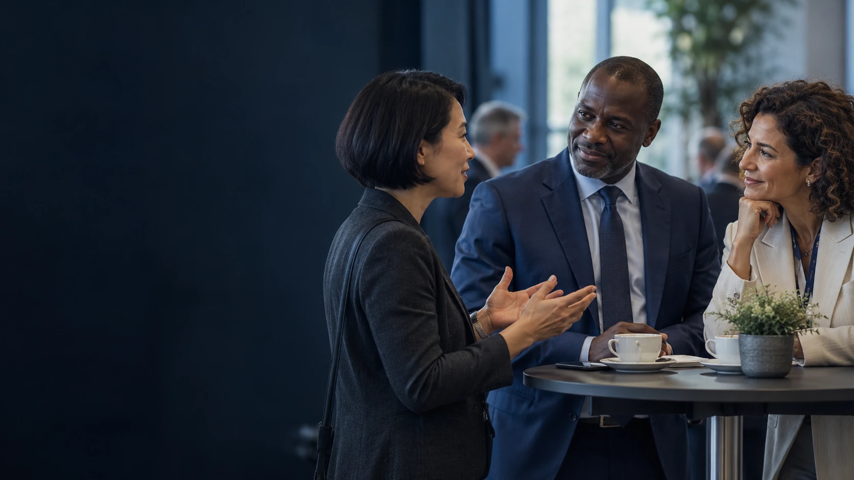 Professionals exchanging ideas during a small international conference.